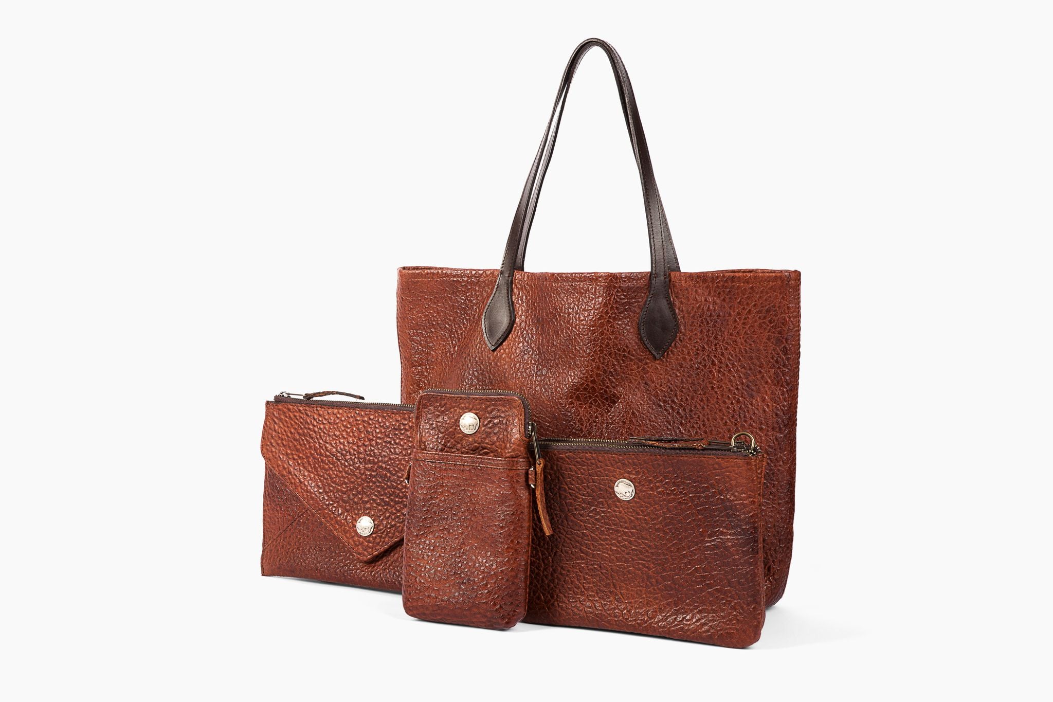 American Bison Bags in Cinnamon color tone, "Bubble"  texture - #3000 Large Tote, front row L to R #3766 Crossbody Clutch, #3760 Ultimate Travel Crossbody, #3745 Dual Compartment Crossbody